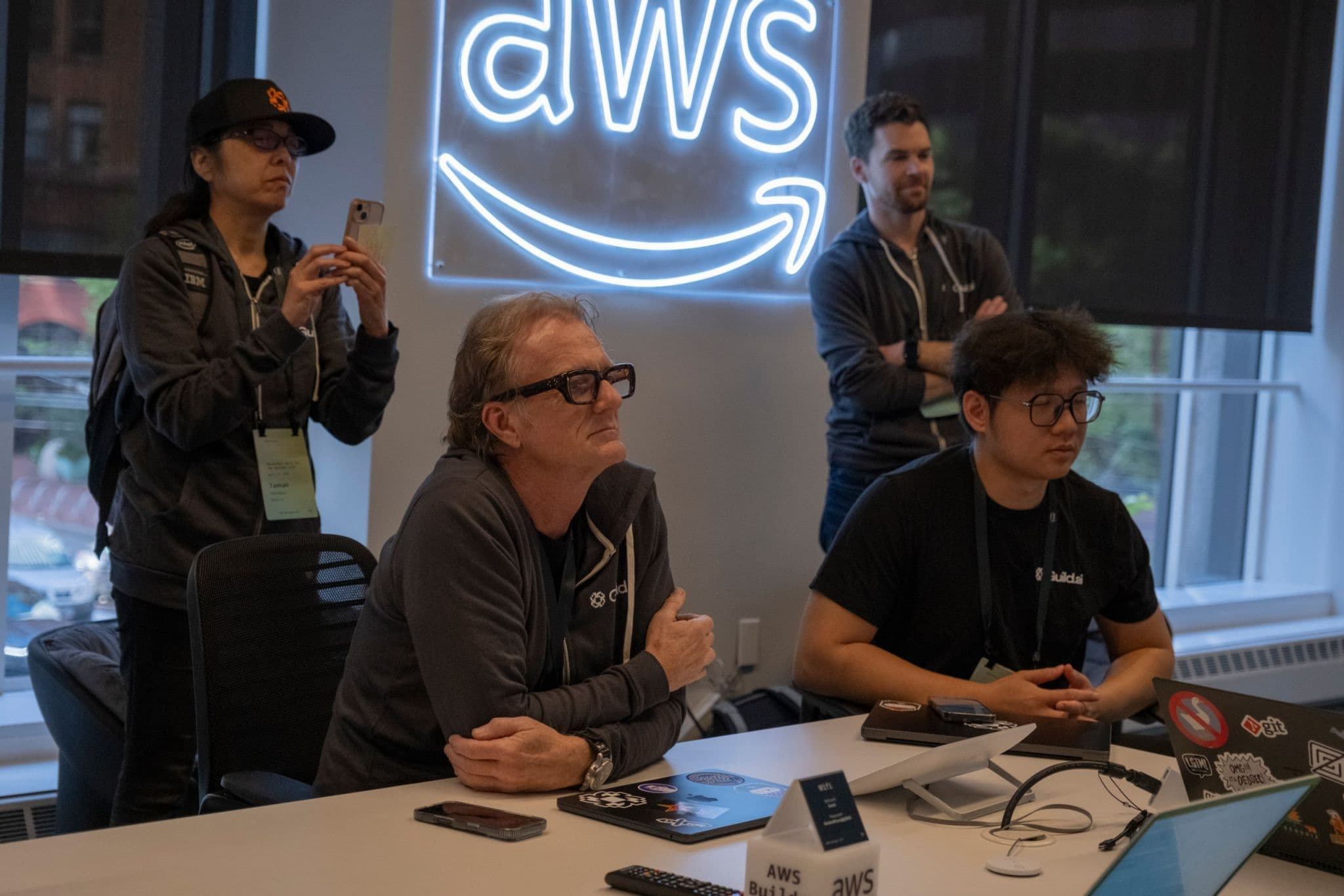 Developers and mentors watching a demo in an AWS event room.
